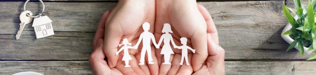 paper cut out of people held in a hand supporting families after suicide