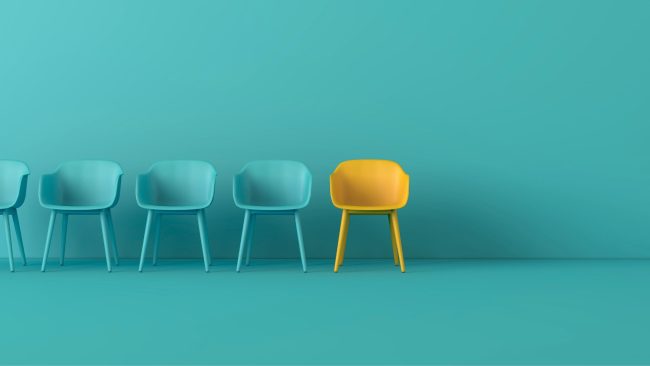 a row of green chairs and one yellow chair