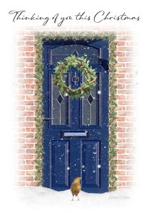 Blue door with christmas wreath and the words thinking of you this christmas above the door. robin outside the door.