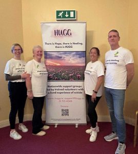 HUGG Waterford Volunteers standing in front of a HUGG banner
