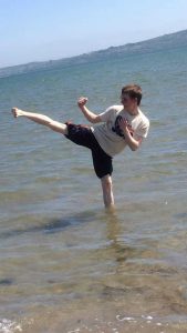 Sean practicing Taekwondo on the beach