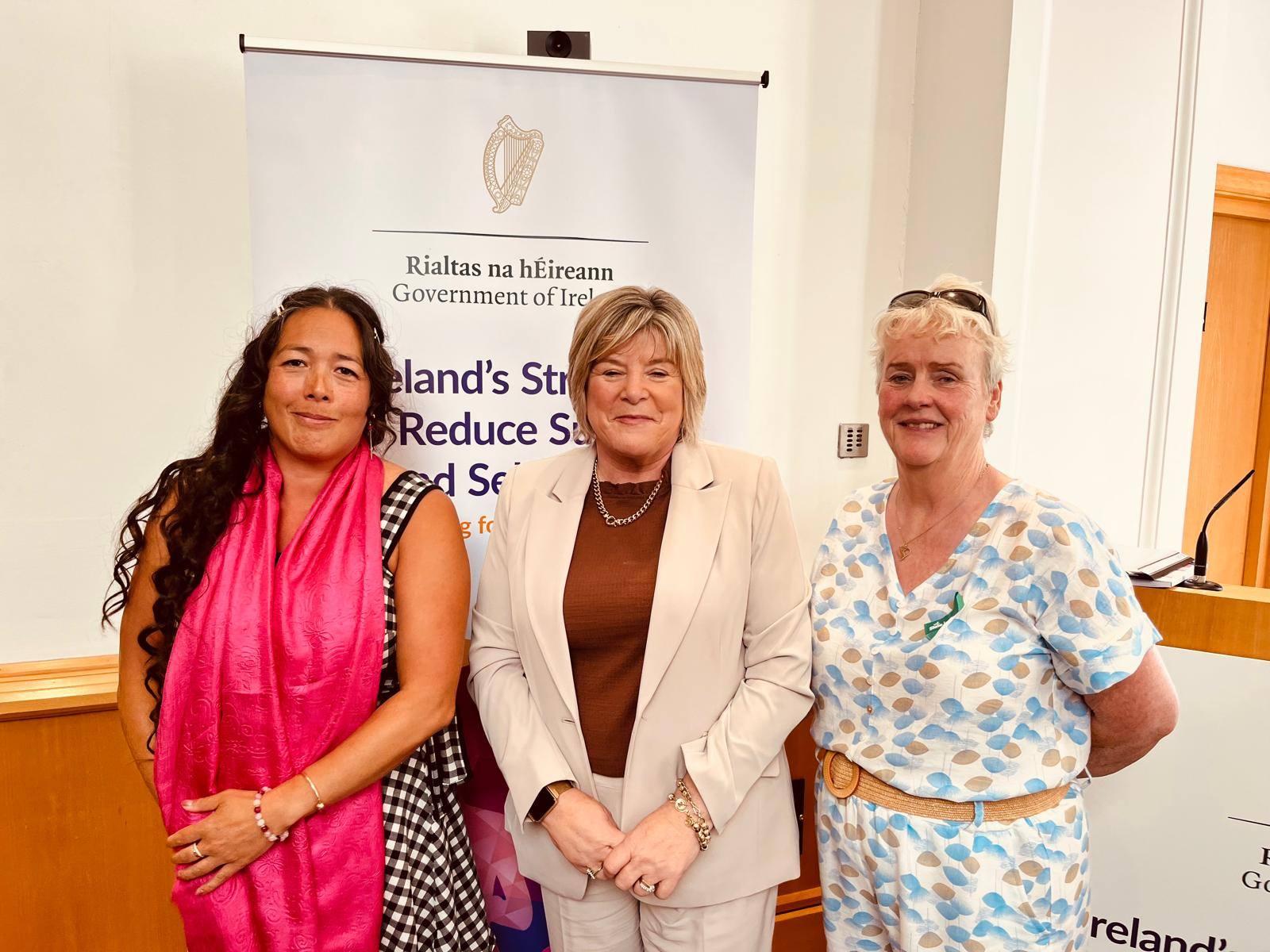 photo of minister for mental health, and two HUGG Volunteers