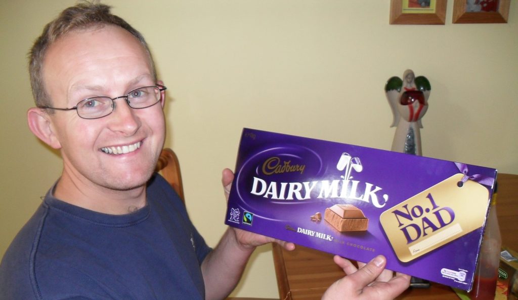 a picture of elaine o'donovans husband kevin who she lost to suicide holding a chocolate bar HUGG. hope stories elaine odonovan