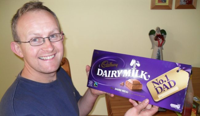 a picture of elaine o'donovans husband kevin who she lost to suicide holding a chocolate bar HUGG. hope stories elaine odonovan